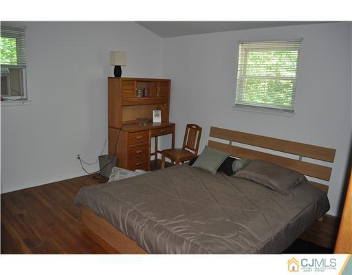 16 Donald Road East Brunswick, NJ 08816 - Photo 16 of 25 a bedroom with a bed and window