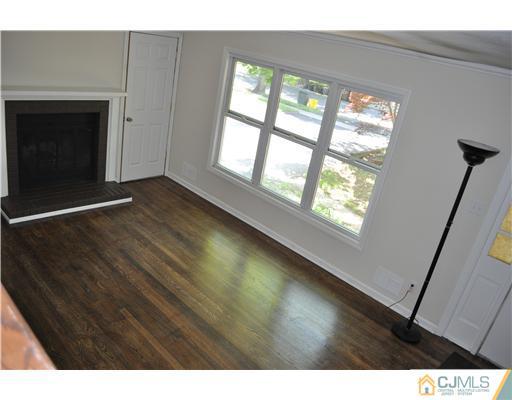 16 Donald Road East Brunswick, NJ 08816 - Photo 4 of 25 a view of an empty room with wooden floor and a window