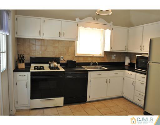 16 Donald Road East Brunswick, NJ 08816 - Photo 9 of 25 a kitchen with a sink and cabinets