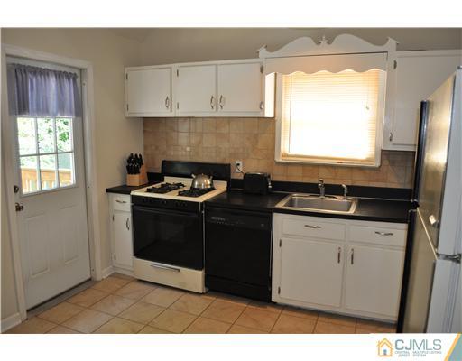 16 Donald Road East Brunswick, NJ 08816 - Photo 10 of 25 a kitchen with a sink stove and cabinets