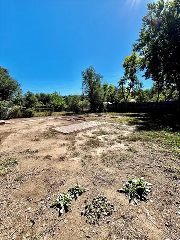 a backyard of a house with wooden fence