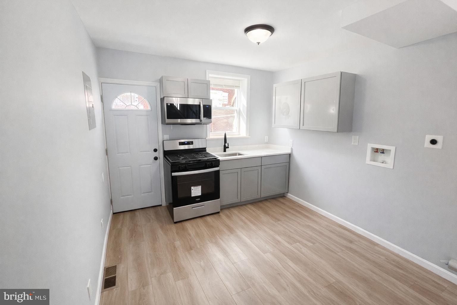 510 North Duncan Street Baltimore, MD 21205 - Photo 4 of 8 a kitchen with stainless steel appliances granite countertop a stove a sink and a refrigerator