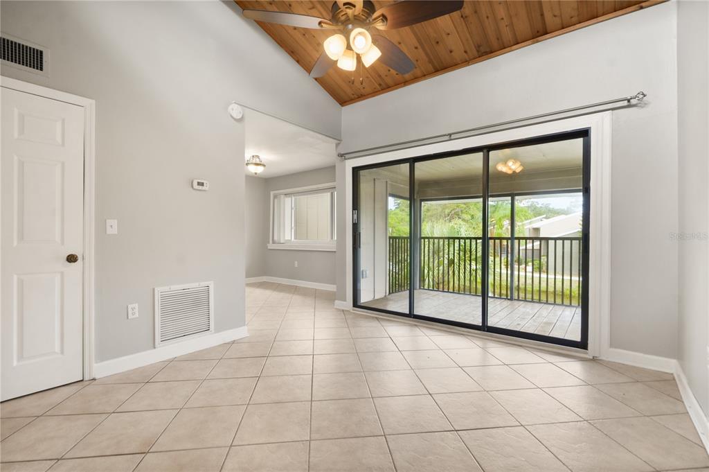 5929 Windhover Drive, Unit A02 Orlando, FL 32819 - Photo 3 of 17 a view of an empty room with a sliding door