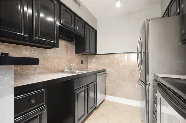 a kitchen with a sink stainless steel appliances and cabinets