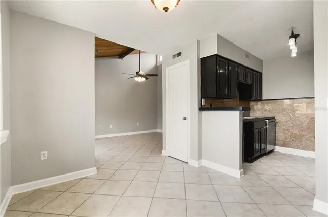 a view of a kitchen with a sink and a refrigerator