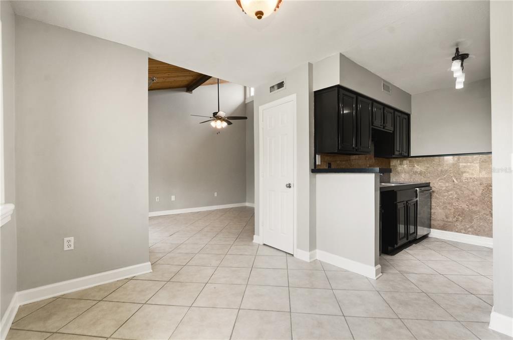 5929 Windhover Drive, Unit A02 Orlando, FL 32819 - Photo 6 of 17 a view of a kitchen with a sink and a refrigerator