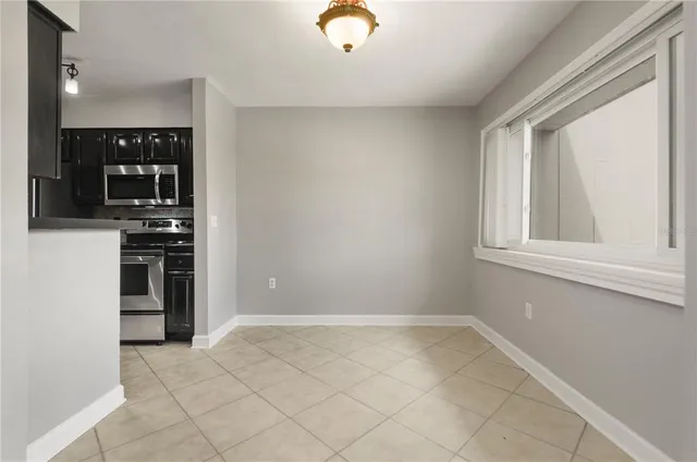 a view of kitchen with microwave and cabinets