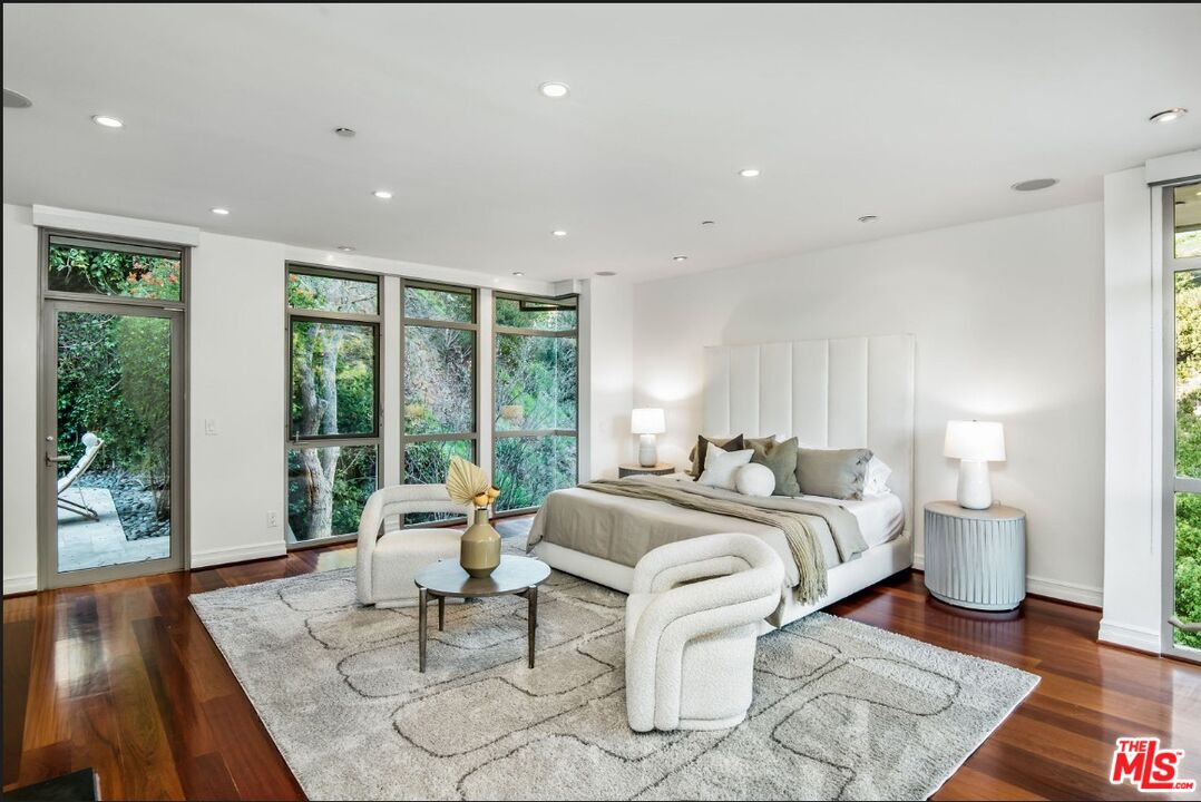 3685 Mandeville Canyon Road Los Angeles, CA 90049 - Photo 13 of 24 a living room with furniture and wooden floor