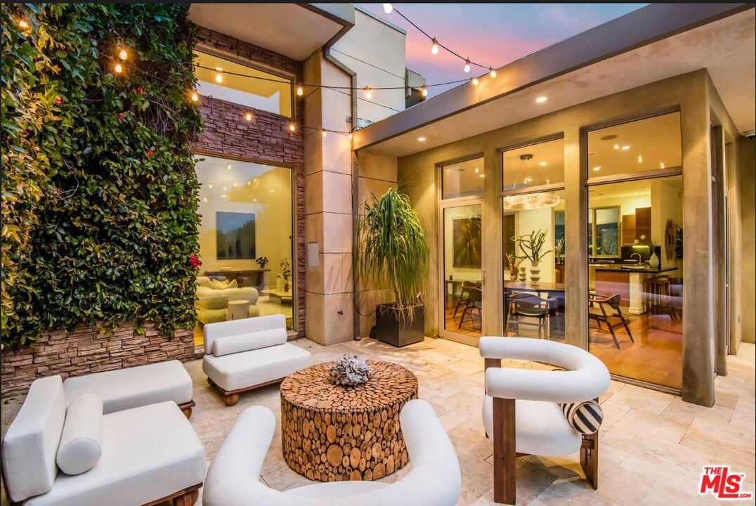 3685 Mandeville Canyon Road Los Angeles, CA 90049 - Photo 21 of 24 a balcony with furniture and a potted plant