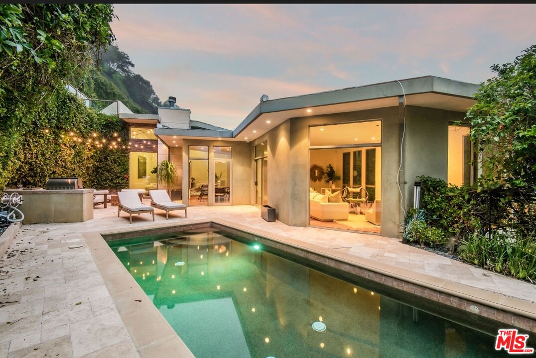 3685 Mandeville Canyon Road Los Angeles, CA 90049 - Photo 23 of 24 a view of swimming pool is sitting area in front of house