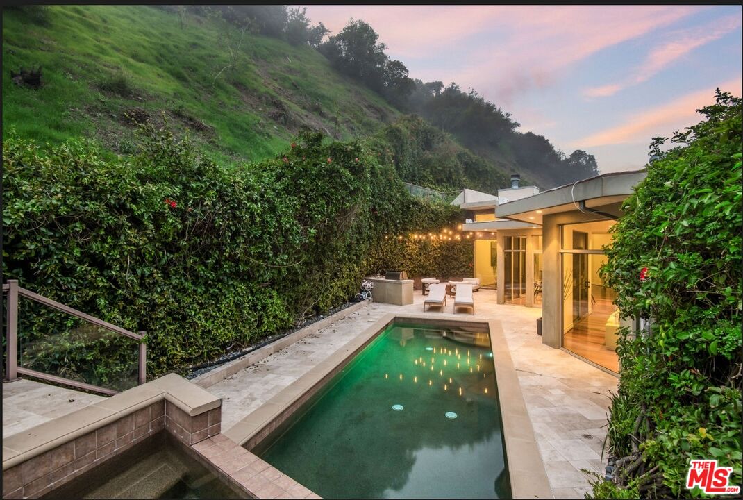 3685 Mandeville Canyon Road Los Angeles, CA 90049 - Photo 24 of 24 a view of a patio with table and chairs and potted plants