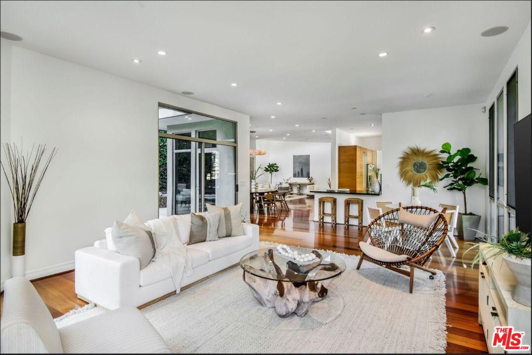 3685 Mandeville Canyon Road Los Angeles, CA 90049 - Photo 5 of 24 a living room with furniture and floor to ceiling windows