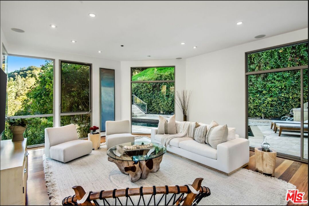 3685 Mandeville Canyon Road Los Angeles, CA 90049 - Photo 6 of 24 a living room with furniture and a large window