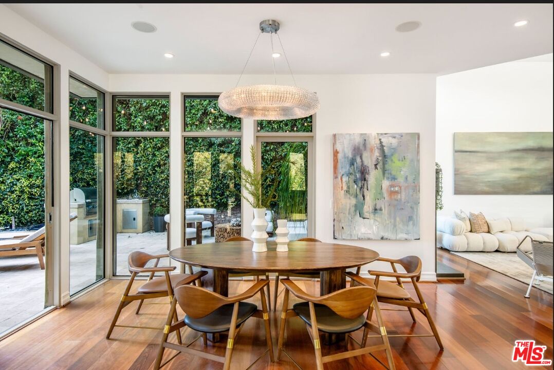 3685 Mandeville Canyon Road Los Angeles, CA 90049 - Photo 7 of 24 a dining room with furniture window and outside view