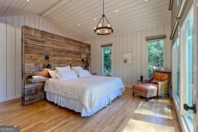 a bathroom with a granite countertop sink a mirror and shower