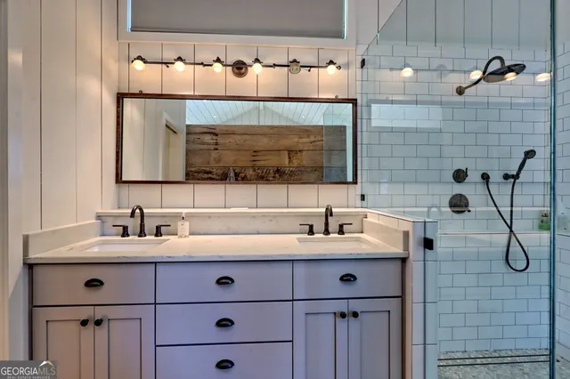a bathroom with a granite countertop sink a toilet and shower
