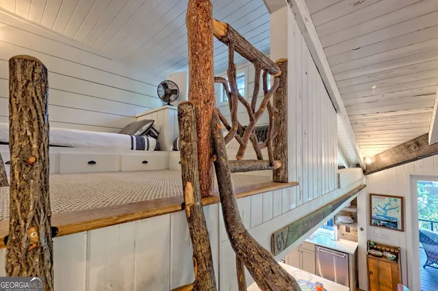 a view of a patio with table and chairs with wooden floor and fence