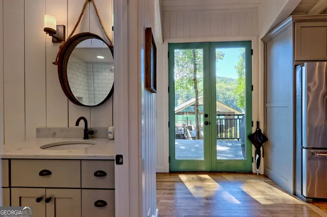 a front view of a house with a garden and lake view