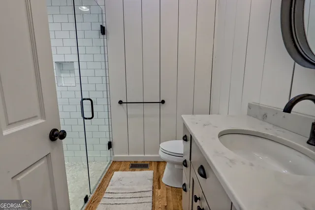 an aerial view of a golf course with a lake