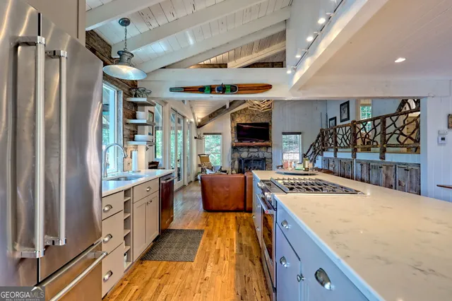 a kitchen with stainless steel appliances granite countertop a stove and a refrigerator