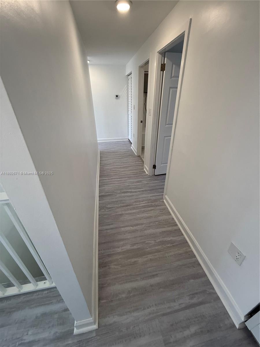 13984 Southwest 259th Street, Unit 13984 Homestead, FL 33032 - Photo 15 of 67 a view of a hallway with wooden floor and staircase