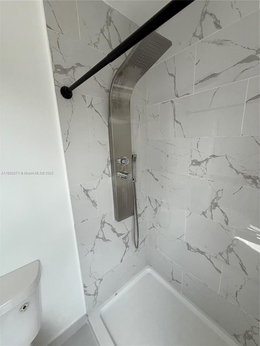 13984 Southwest 259th Street, Unit 13984 Homestead, FL 33032 - Photo 20 of 67 a bathroom with a bathtub and a shower