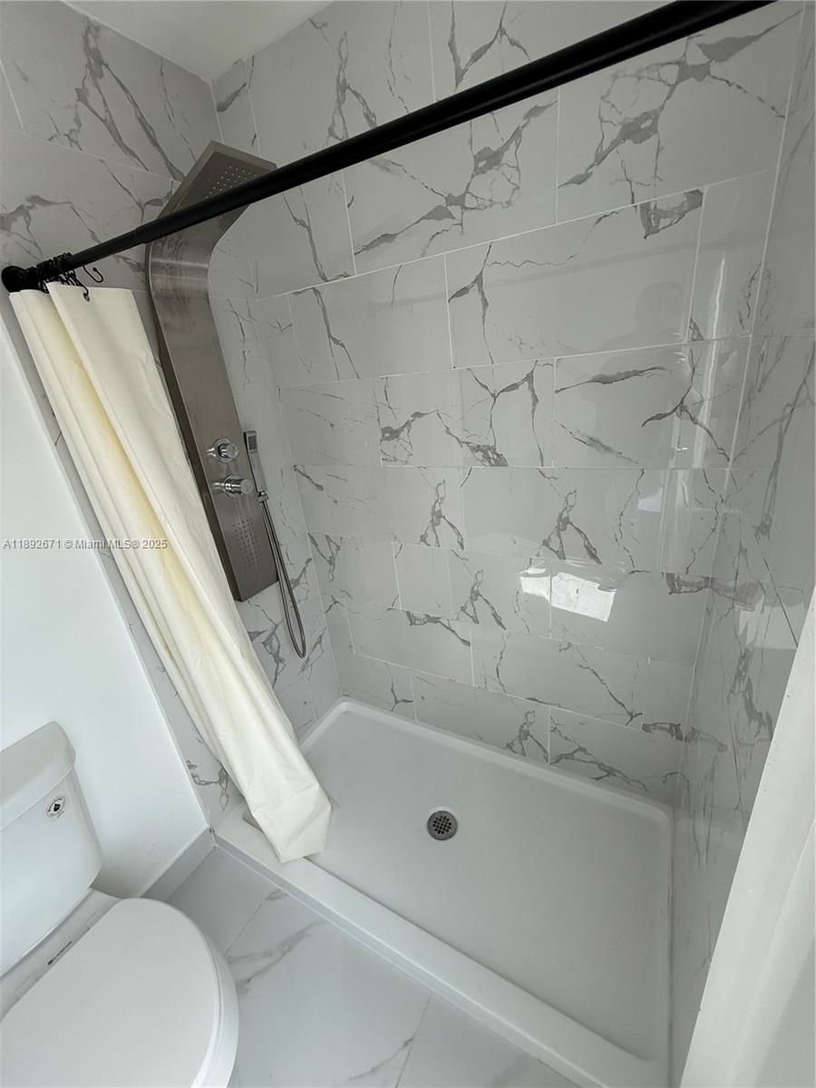 13984 Southwest 259th Street, Unit 13984 Homestead, FL 33032 - Photo 22 of 67 a bathroom with a shower and toilet