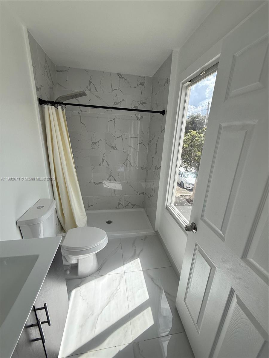 13984 Southwest 259th Street, Unit 13984 Homestead, FL 33032 - Photo 27 of 67 a bathroom with a toilet and a shower