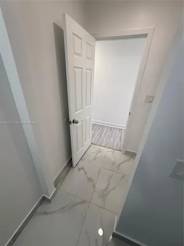 en empty room with wooden floor and window