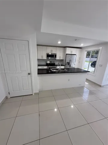 a kitchen with stainless steel appliances granite countertop a sink and cabinets