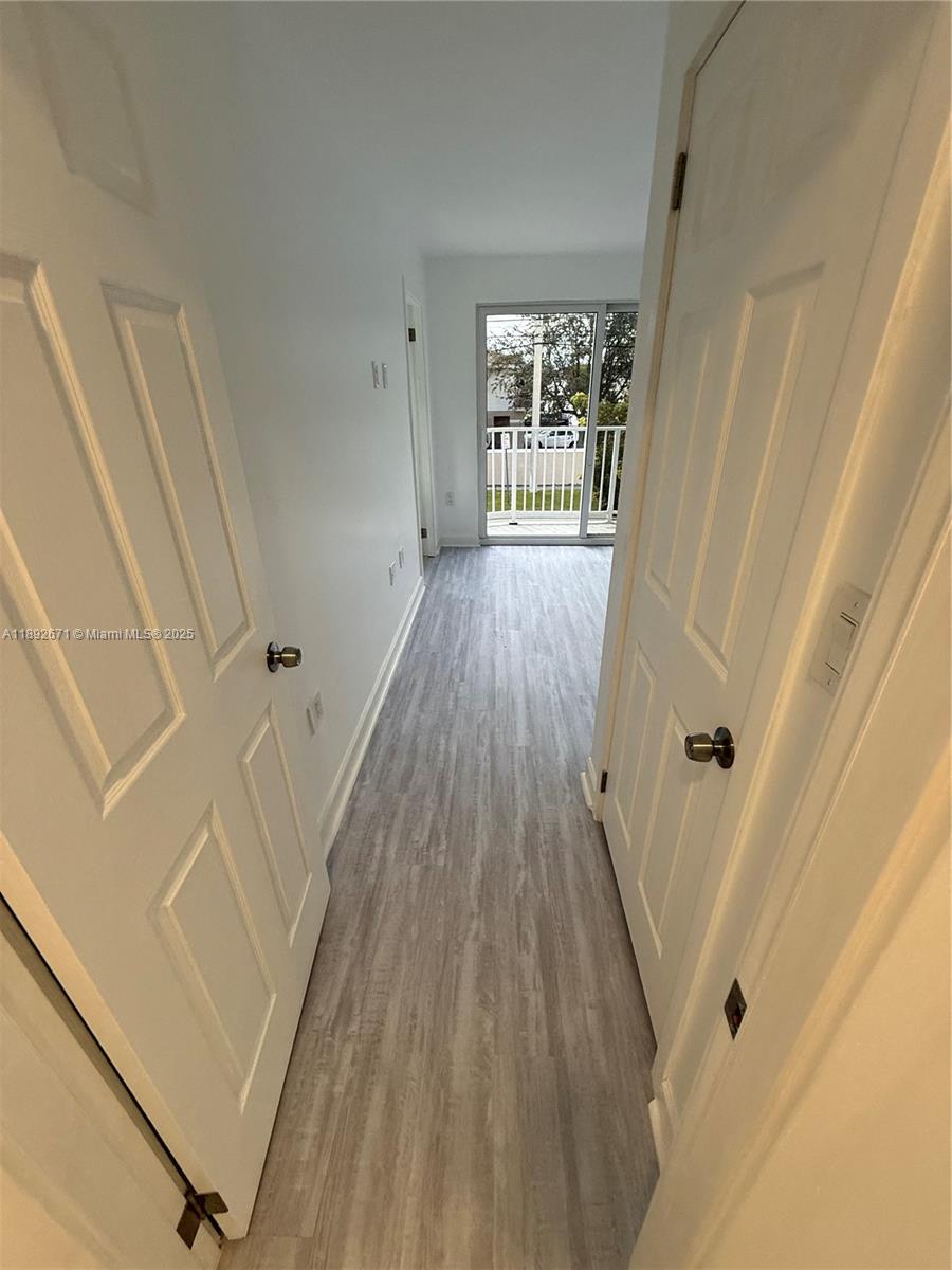 13984 Southwest 259th Street, Unit 13984 Homestead, FL 33032 - Photo 32 of 67 a view of a hallway with wooden floor and staircase