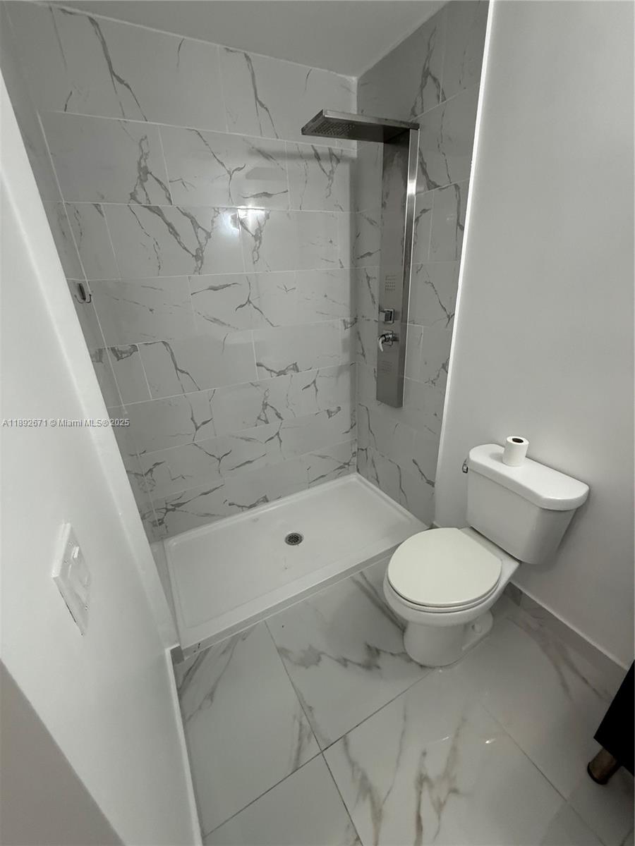13984 Southwest 259th Street, Unit 13984 Homestead, FL 33032 - Photo 35 of 67 a bathroom with a toilet and a shower