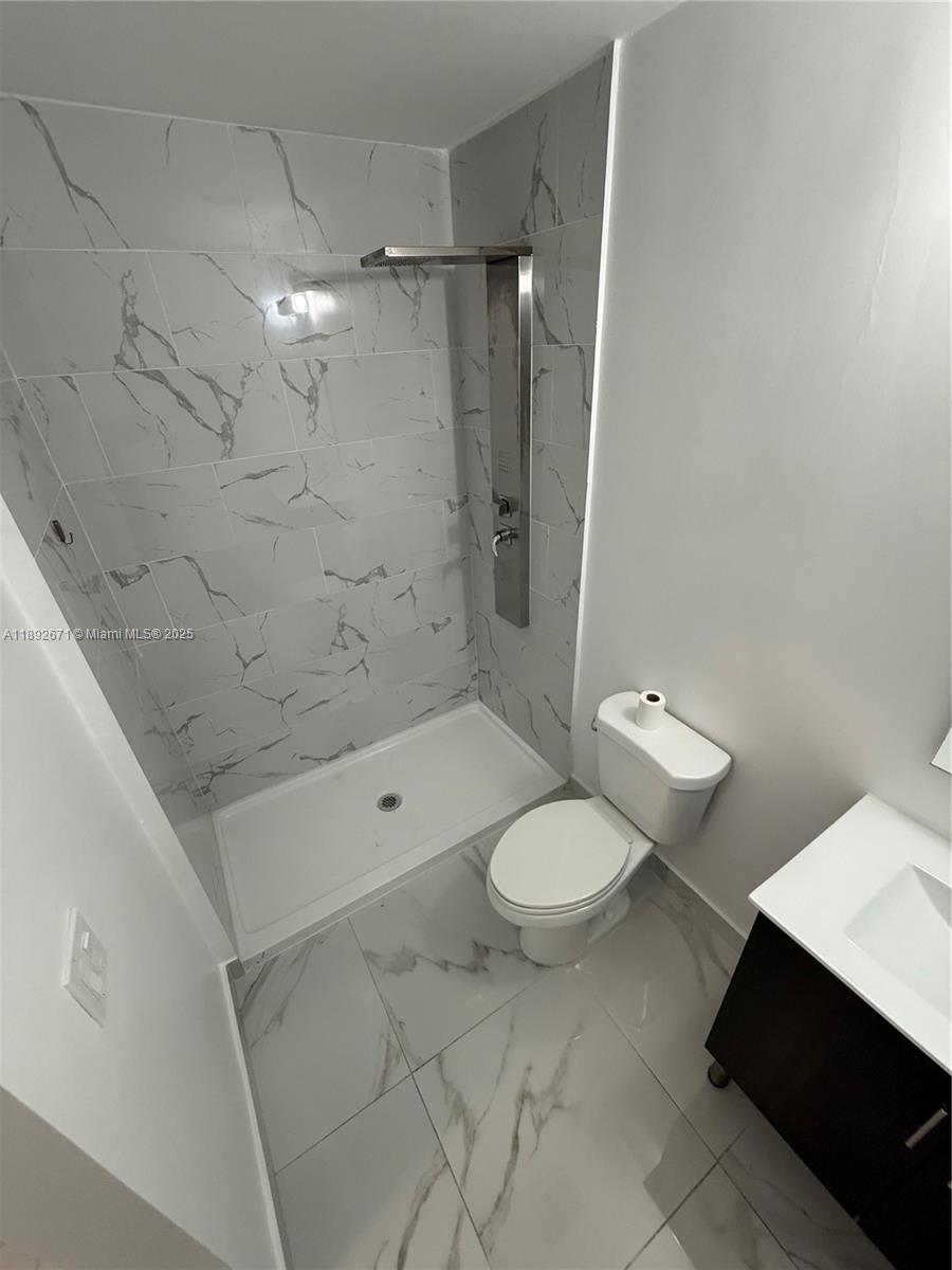 13984 Southwest 259th Street, Unit 13984 Homestead, FL 33032 - Photo 36 of 67 a bathroom with a shower toilet and sink