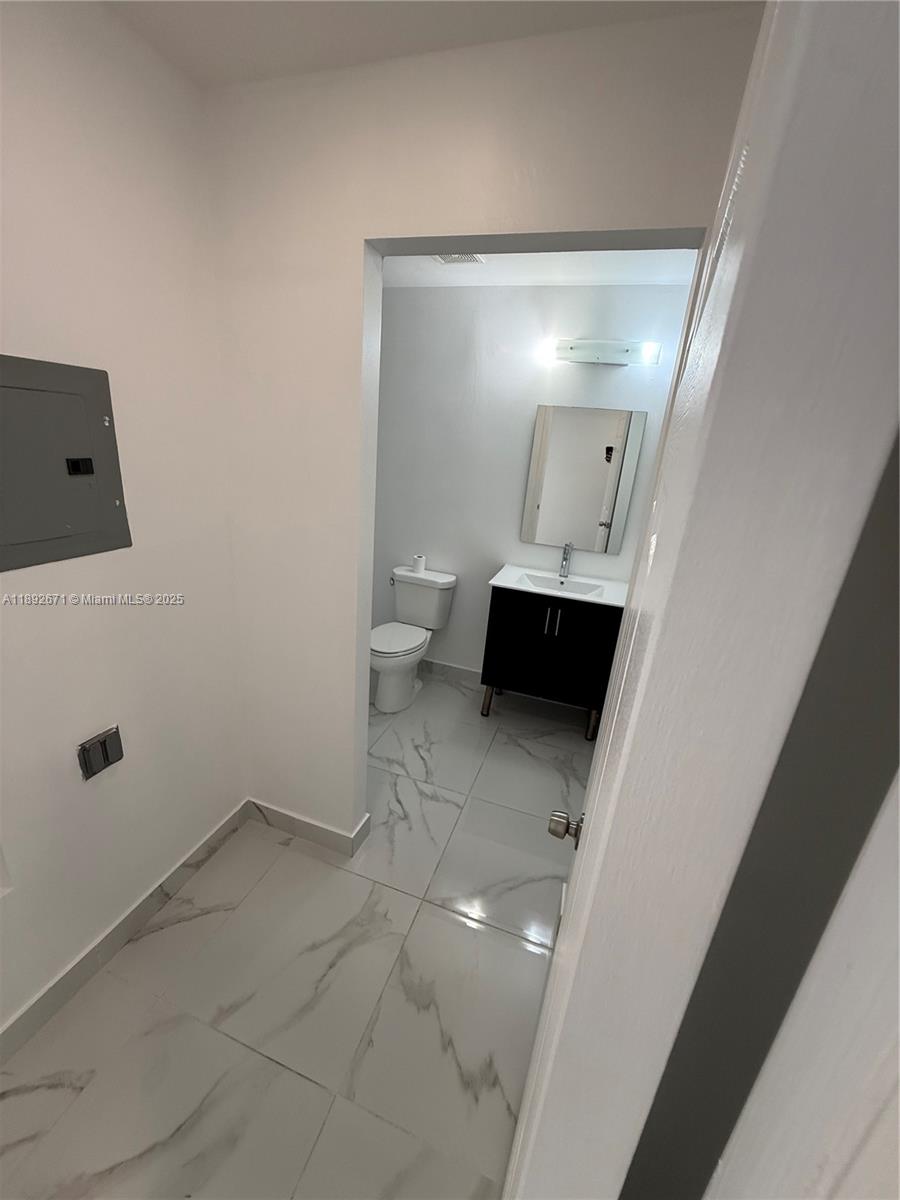 13984 Southwest 259th Street, Unit 13984 Homestead, FL 33032 - Photo 37 of 67 a view of a bathroom with a sink and mirror