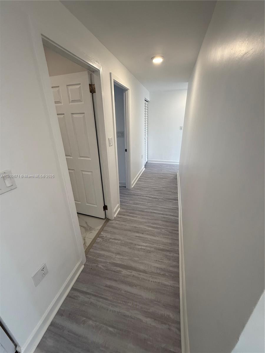 13984 Southwest 259th Street, Unit 13984 Homestead, FL 33032 - Photo 39 of 67 a view of a hallway with wooden floor