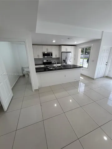 a kitchen with a sink and a stove top oven