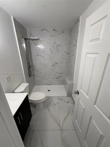 a bathroom with a sink toilet and a mirror