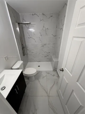 a view of a room has a projector and cabinets