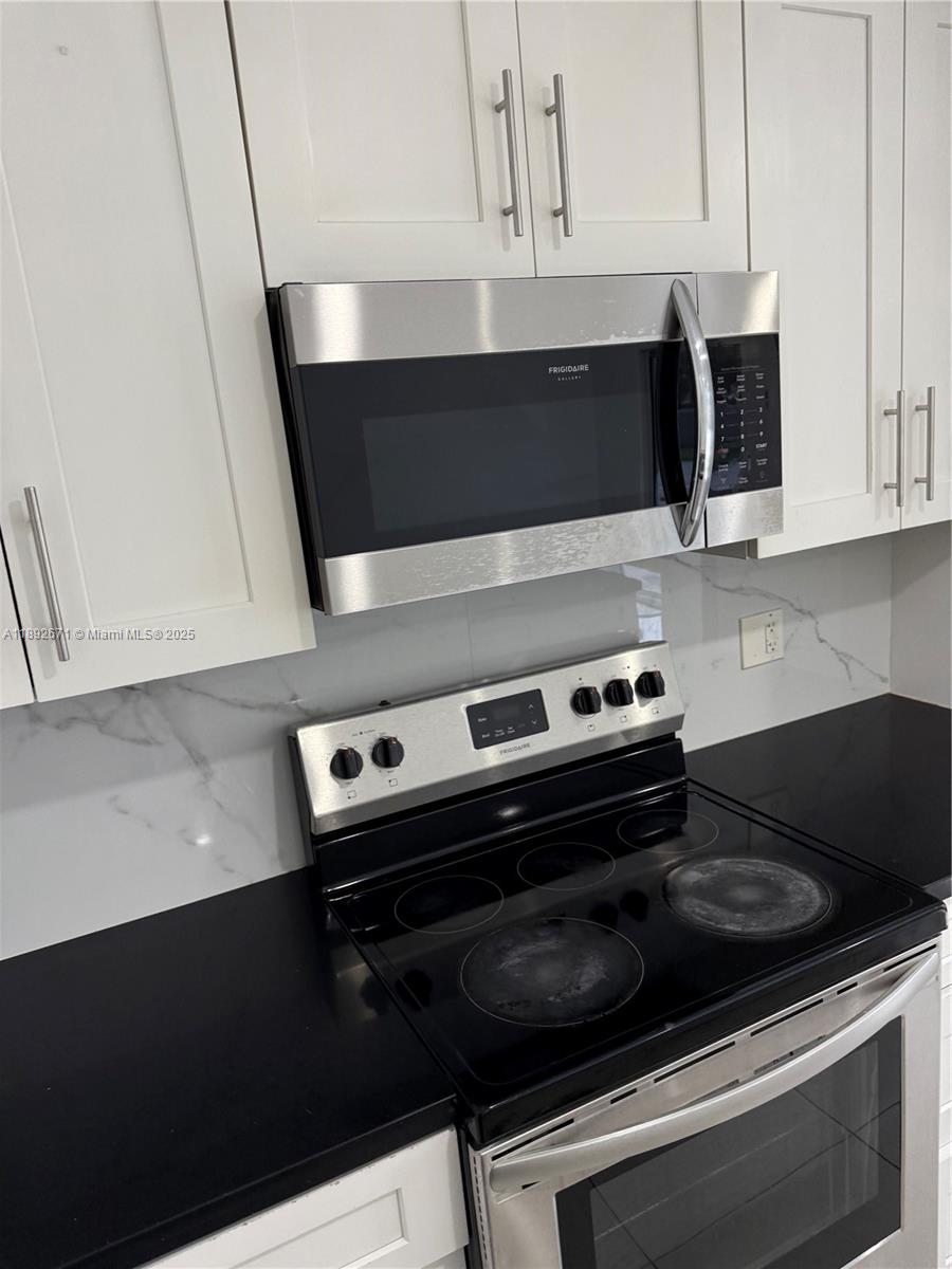 13984 Southwest 259th Street, Unit 13984 Homestead, FL 33032 - Photo 59 of 67 a stove top oven sitting inside of a kitchen
