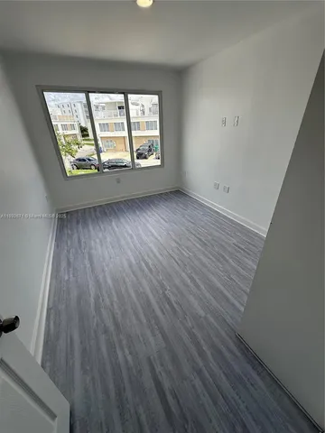 a kitchen with stainless steel appliances a sink a stove a microwave a sink a refrigerator and cabinets