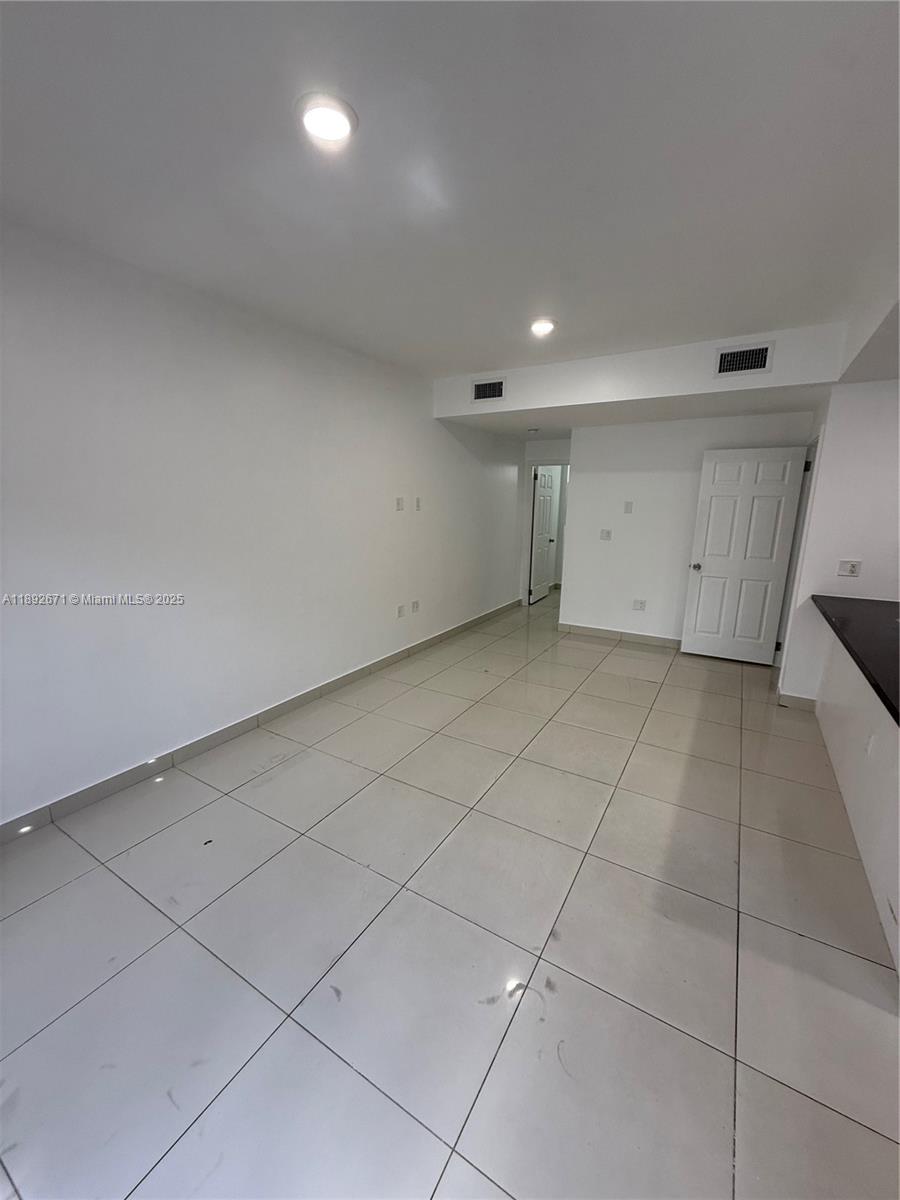 13984 Southwest 259th Street, Unit 13984 Homestead, FL 33032 - Photo 66 of 67 a view of a room has a projector and cabinets