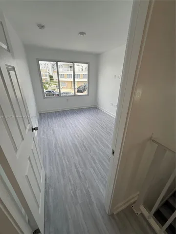 a view of hallway with wooden floor