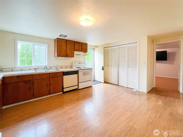 a view of a kitchen with a sink and a window