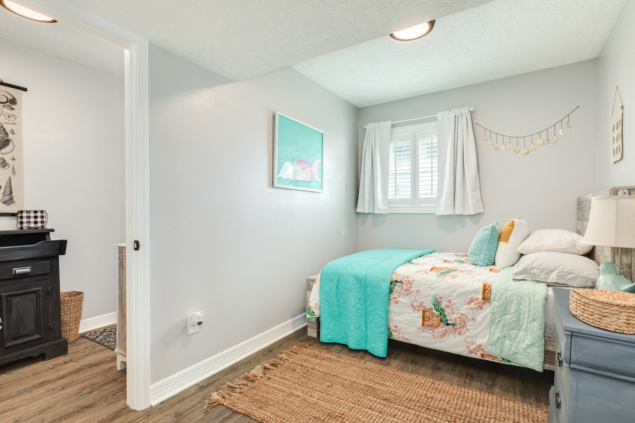 722 Beach Drive Surfside Beach, TX 77541 - Photo 21 of 34 a bedroom with a bed and wooden floor
