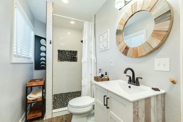 a bathroom with a toilet a sink and a mirror