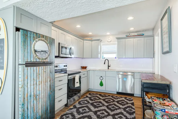 a kitchen with a stove a sink and a refrigerator