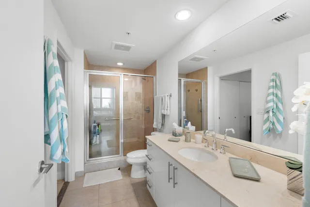 a bathroom with a double vanity sink toilet and shower