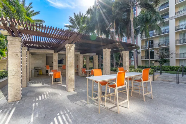 a view of a patio with table and chairs and potted plants