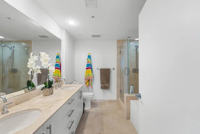 a bathroom with a double vanity sink and a mirror