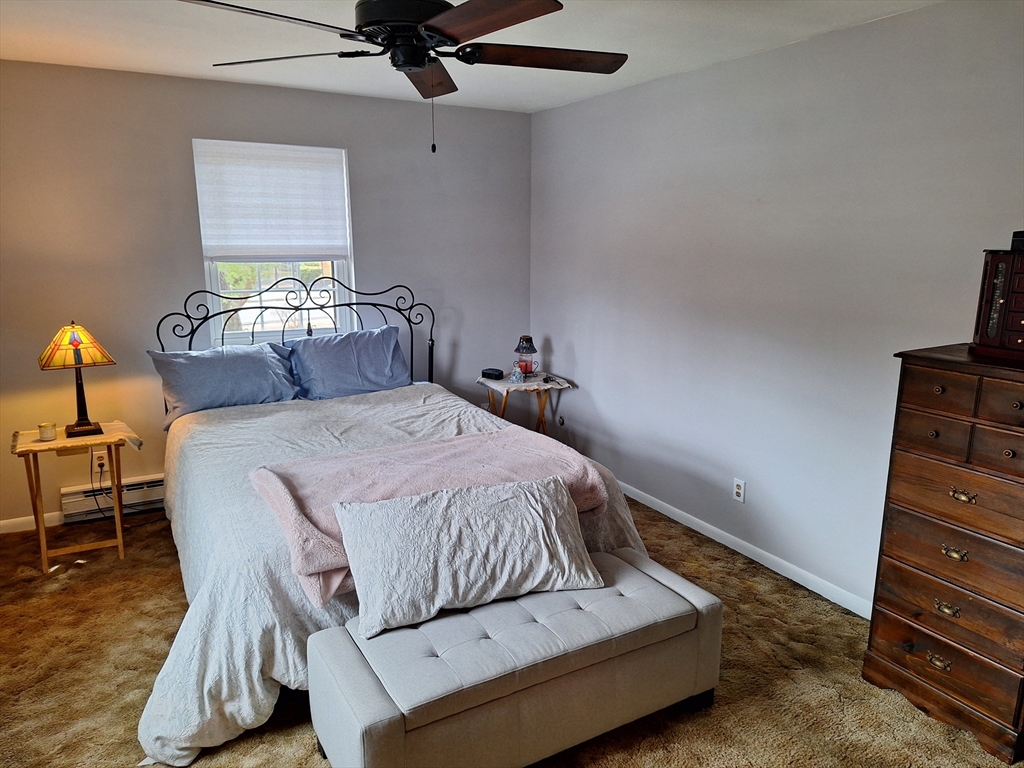 39 West Street, Unit B1 Randolph, MA 02368 - Photo 11 of 15 a bedroom with a bed and a dresser
